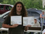 Billy Shanahan displays his awards for Big Carp and Longest Carp (17 lb, 8 oz and 31.5_) in the Amateur Class.