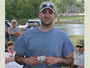 A happy angler displays a gift card to Dick's Sporting Goods of Clay that he won during the prize raffle.