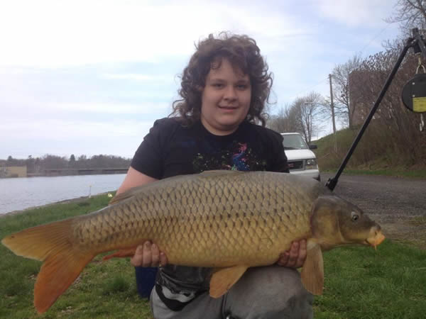 Nathaniel holding Don Knowles' 29.13 lb common caught during session 1 of the Wild Carp Club of Central Fish.