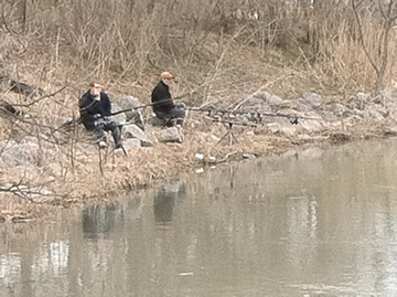 From left) Josh Carnright and Jamie Godkin found a quiet spot along the stream leading into the Inner Harbor.