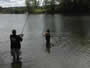 Young Nathaniel helps Tom Chairvolotti net his fish.