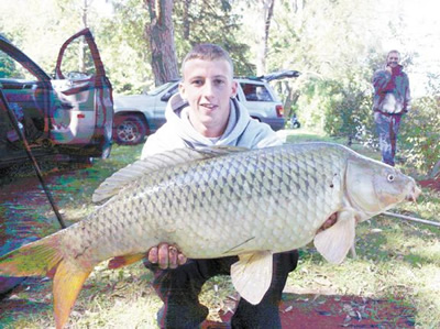 Sean Lehrer displays a nice 18 lb. 6 oz. common carp caught during Session four of Wild Carp Club, which was formed as part of Wild Carp Companies