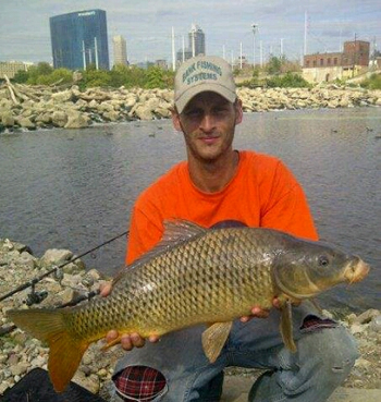 Club director Justin Keaton with a common carp caught in Indiana