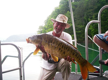 Wild Carp Club of Indiana Director Gilbert Huxley with a 26.8 lb mirror carp caught at Dale Hollow Lake in TN